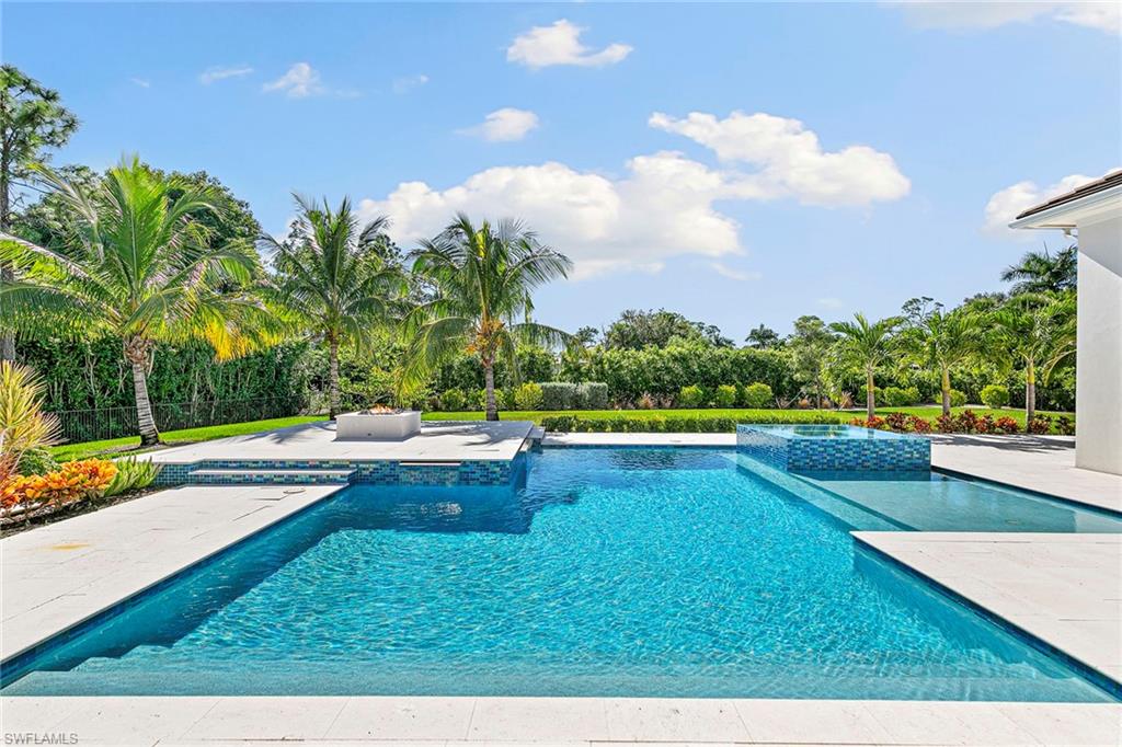 607 Myrtle Road Naples, FL 34108 - Photo 19 of 45 a view of a swimming pool with an outdoor seating and a garden