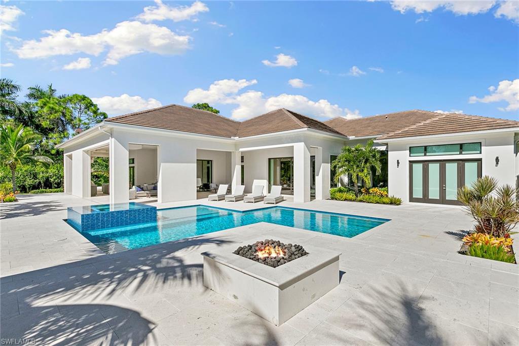 607 Myrtle Road Naples, FL 34108 - Photo 21 of 45 a view of house with swimming pool and outdoor seating
