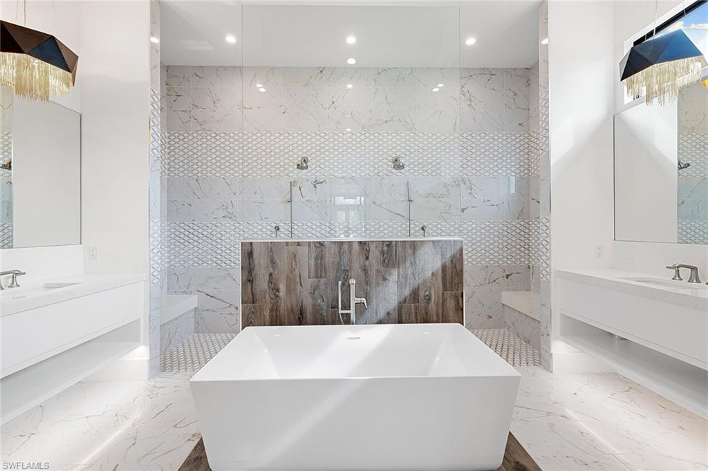 607 Myrtle Road Naples, FL 34108 - Photo 30 of 45 a bathroom with a bathtub and a sink