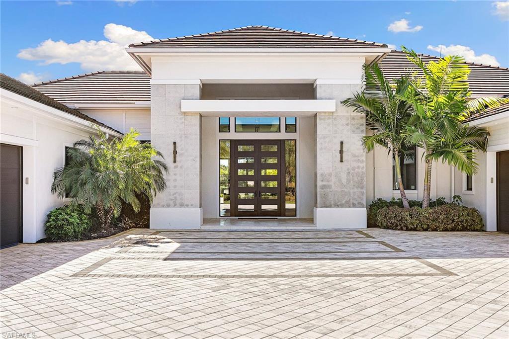 607 Myrtle Road Naples, FL 34108 - Photo 3 of 45 a front view of a house with garden
