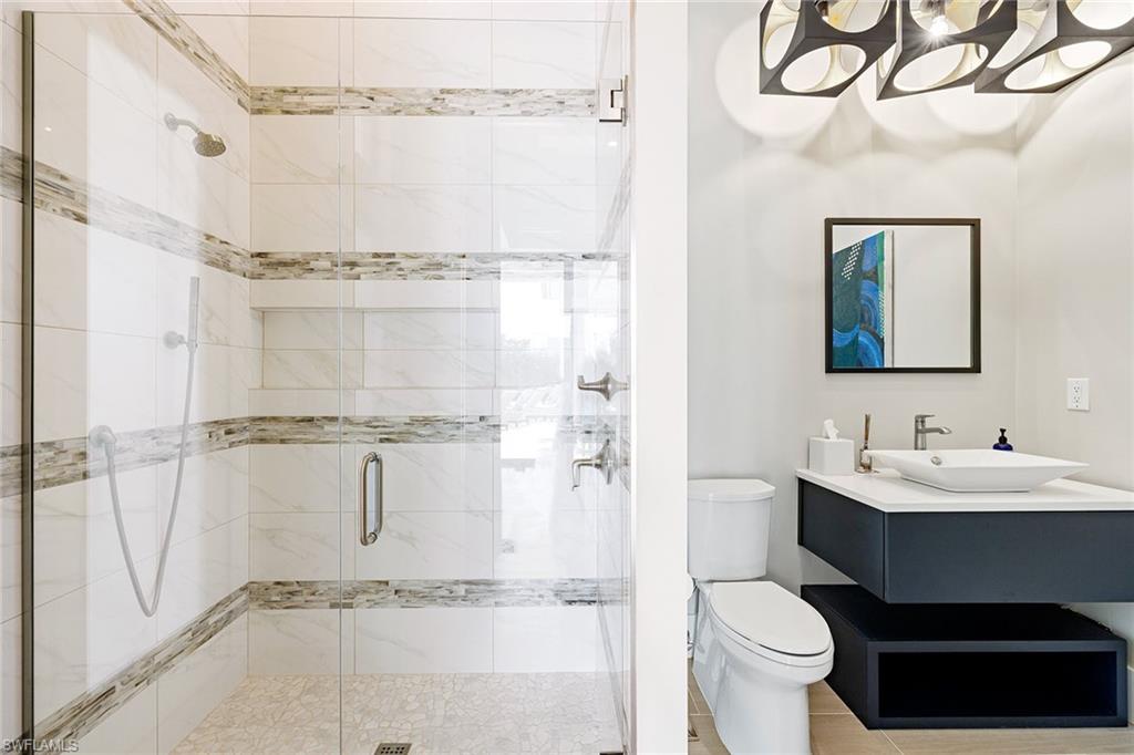 607 Myrtle Road Naples, FL 34108 - Photo 35 of 45 a bathroom with a sink toilet a mirror and shower