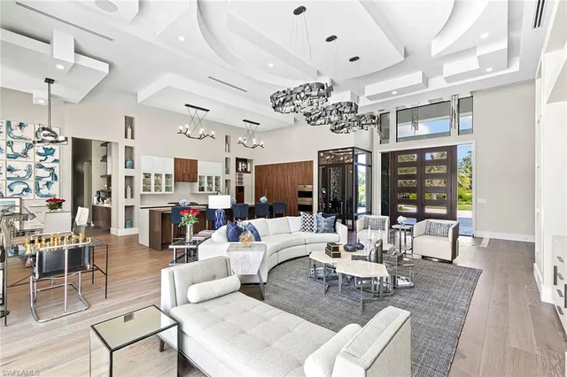 a living room with lots of furniture and chandelier