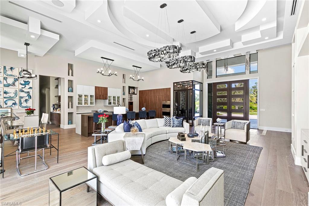 607 Myrtle Road Naples, FL 34108 - Photo 9 of 45 a living room with lots of furniture and chandelier