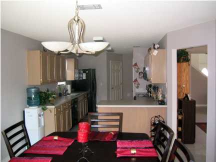 9712 Seafarer's Way Navarre, FL 32566 - Photo 2 of 8 a kitchen with a refrigerator and a stove