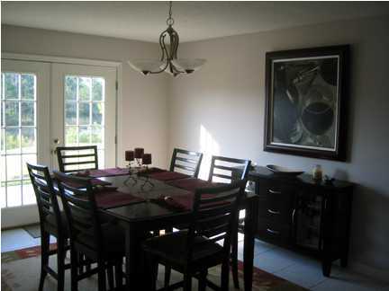 9712 Seafarer's Way Navarre, FL 32566 - Photo 3 of 8 a view of a dining room with furniture window and wooden floor