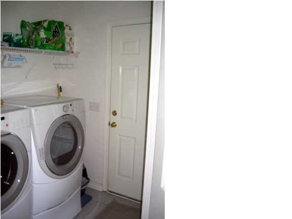 9712 Seafarer's Way Navarre, FL 32566 - Photo 4 of 8 a utility room with dryer and washer