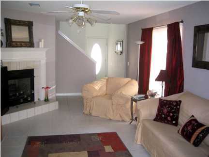 9712 Seafarer's Way Navarre, FL 32566 - Photo 5 of 8 a living room with furniture and a fireplace