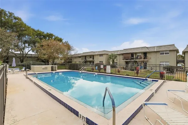 a view of swimming pool outdoor seating and lake view