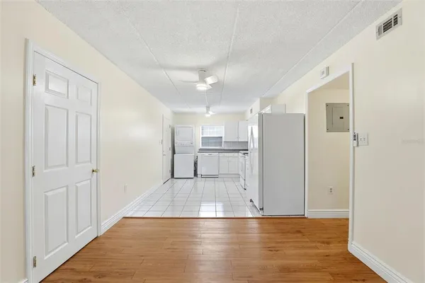 a kitchen with white cabinets and white appliances