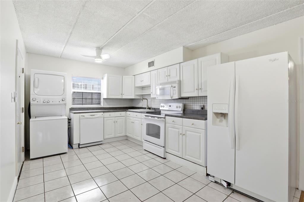 525 South Conway Road, Unit 70 Orlando, FL 32807 - Photo 18 of 28 a kitchen with white cabinets and white appliances