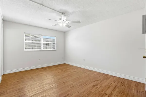 wooden floor in an empty room with a bathroom