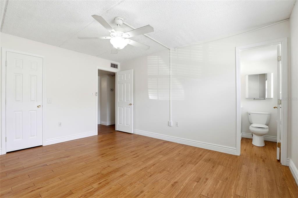 525 South Conway Road, Unit 70 Orlando, FL 32807 - Photo 25 of 28 wooden floor in an empty room with a bathroom