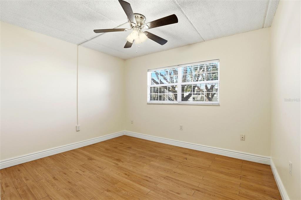 525 South Conway Road, Unit 70 Orlando, FL 32807 - Photo 28 of 28 an empty room with wooden floor and windows