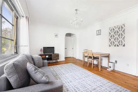 a living room with furniture wooden floor and a flat screen tv