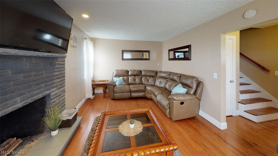 899 River Hill Road Washington, WV 26181 - Photo 4 of 15 Large living room with gorgeous hardwood floor and cozy fireplace.