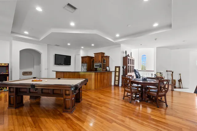 a room with lots of chairs and wooden floor