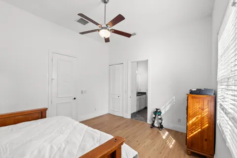 a bedroom with a bed and a tv on the dresser
