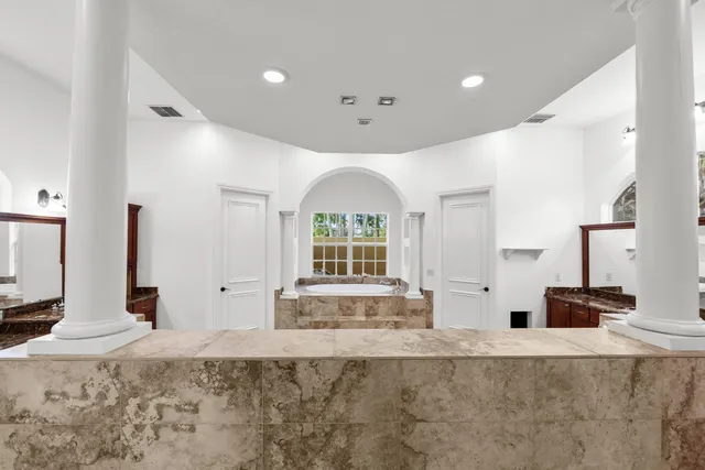 a view of a kitchen with granite countertop a sink and a stove top oven