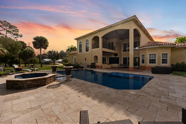 a view of swimming pool with outdoor seating and a yard