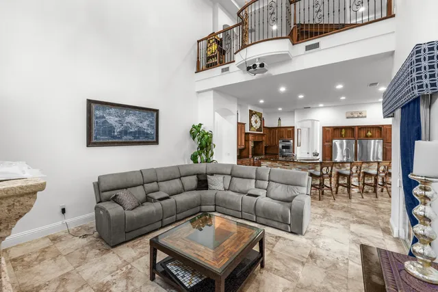 a living room with furniture kitchen view and a table