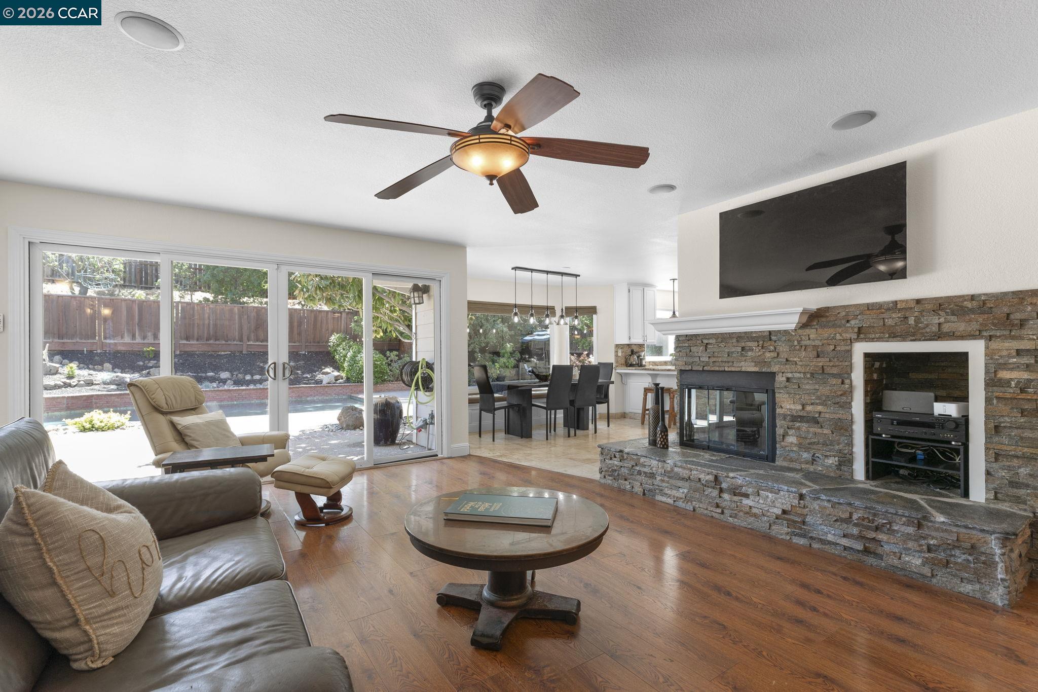 1267 Quiet Circle Concord, CA 94521 - Photo 14 of 72 a living room with fireplace furniture and a flat screen tv