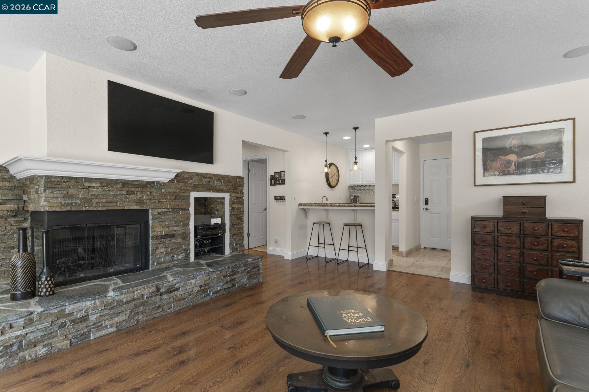 1267 Quiet Circle Concord, CA 94521 - Photo 15 of 72 a living room with furniture a flat screen tv and kitchen view