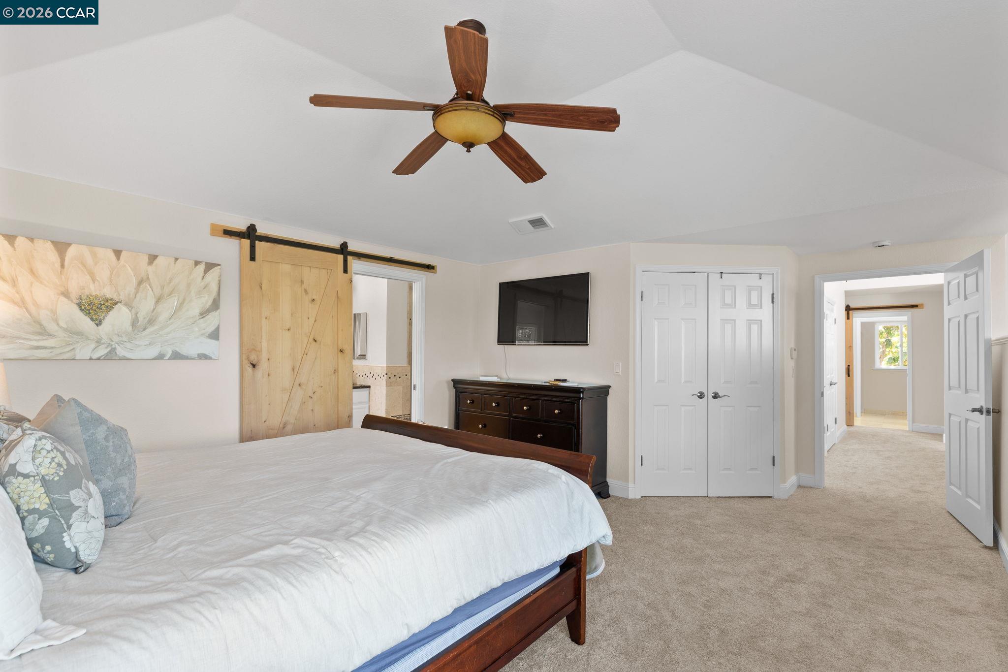 1267 Quiet Circle Concord, CA 94521 - Photo 30 of 72 a bedroom with a bed and a chandelier