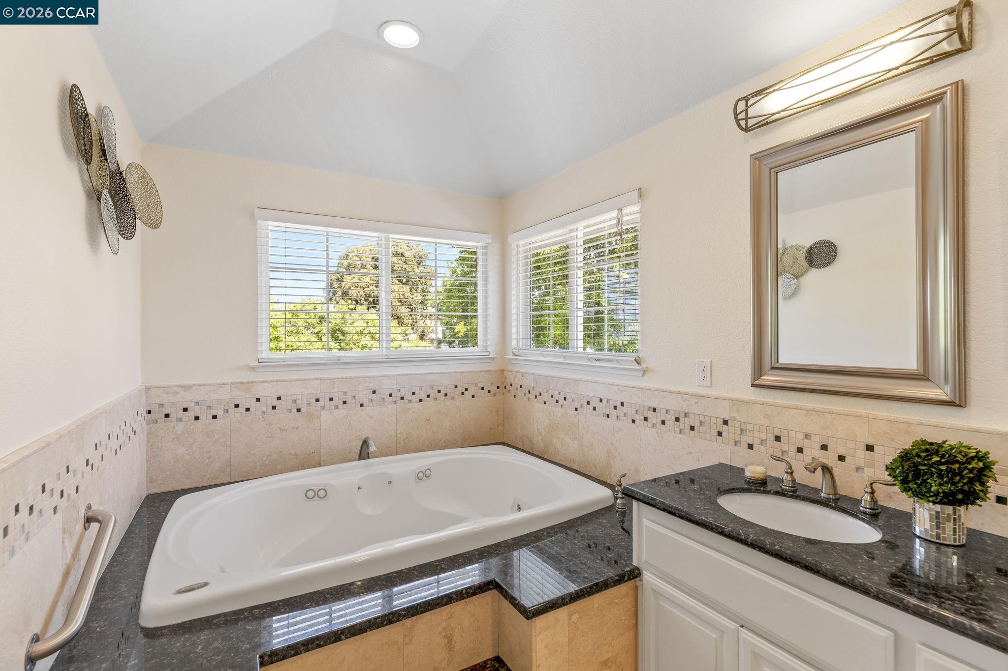1267 Quiet Circle Concord, CA 94521 - Photo 35 of 72 a bathroom with a tub sink and mirror
