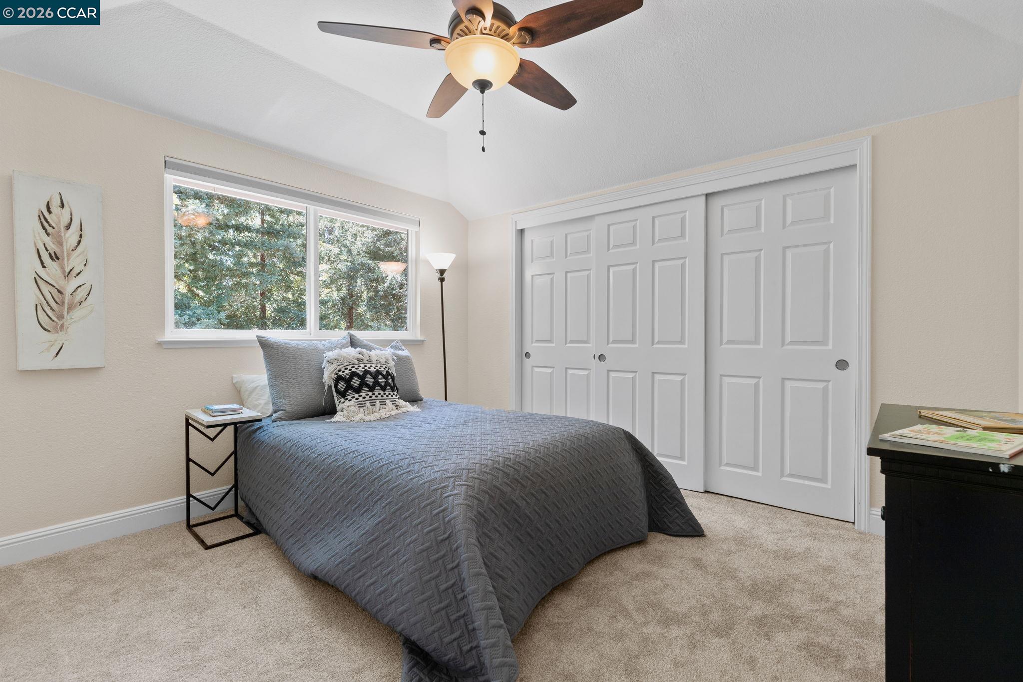 1267 Quiet Circle Concord, CA 94521 - Photo 40 of 72 a bedroom with a bed and a chandelier