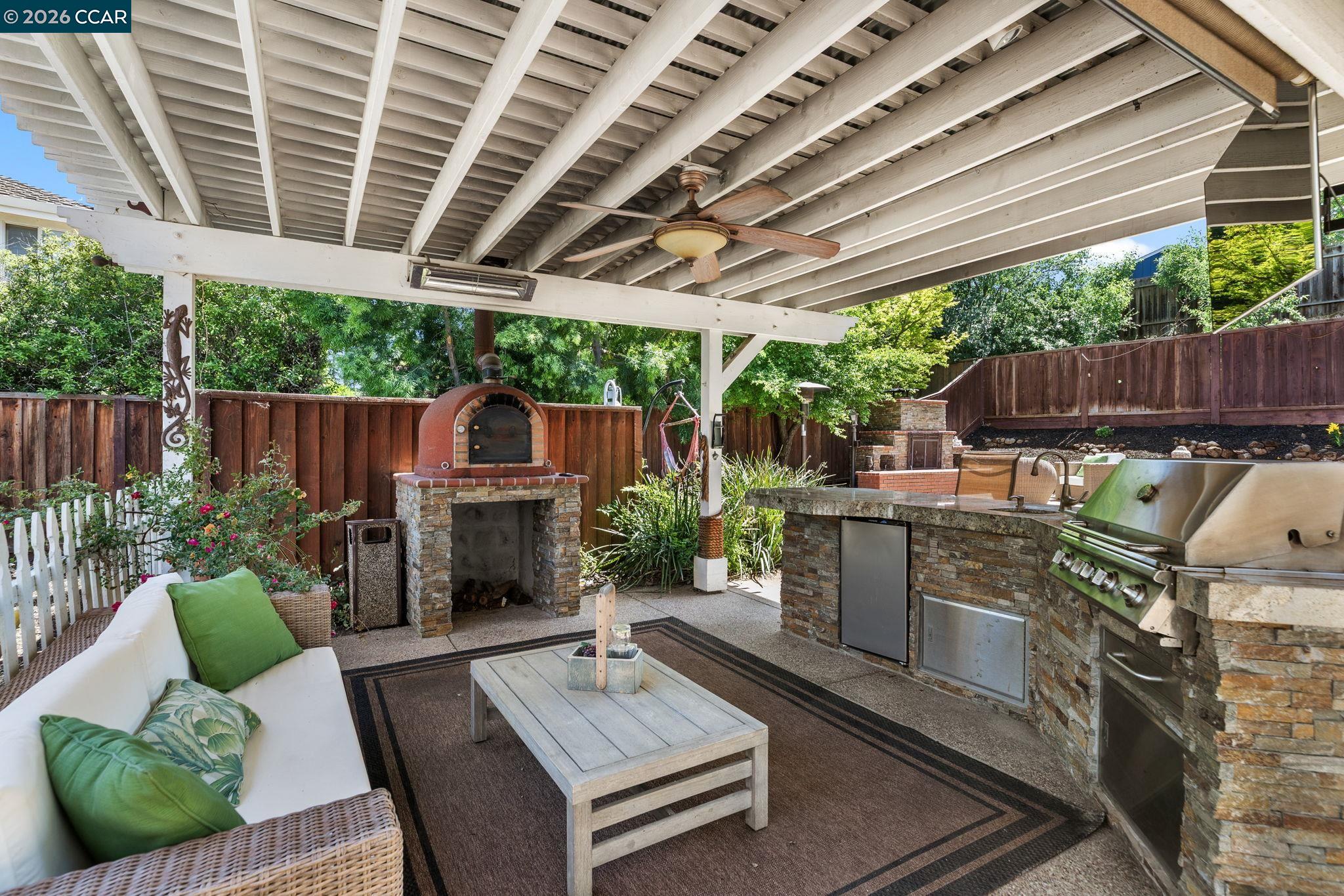 1267 Quiet Circle Concord, CA 94521 - Photo 57 of 72 a view of a patio with table and chairs potted plants and wooden fence