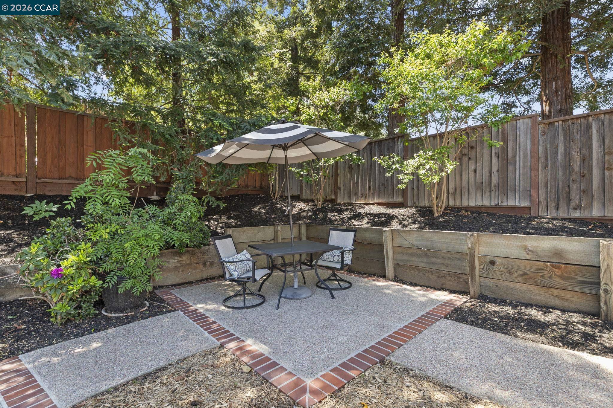 1267 Quiet Circle Concord, CA 94521 - Photo 60 of 72 a view of a patio with table and chairs under an umbrella