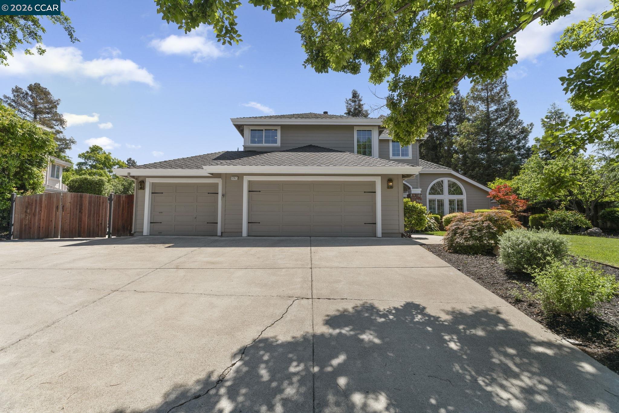1267 Quiet Circle Concord, CA 94521 - Photo 71 of 72 a front view of a house with a yard and garage
