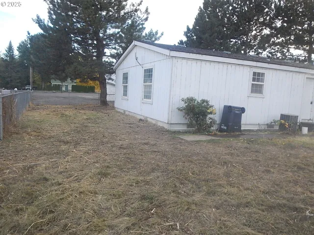 a view of a room with wooden floor and window
