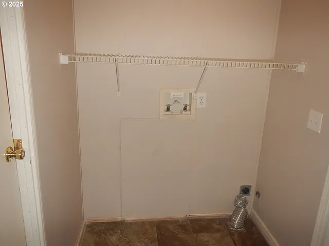 a bathroom with a granite countertop toilet and a sink
