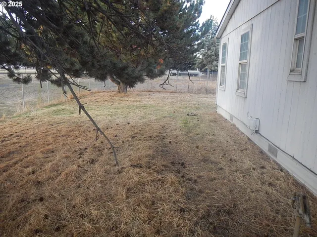 a view of a yard covered with snow in front of house