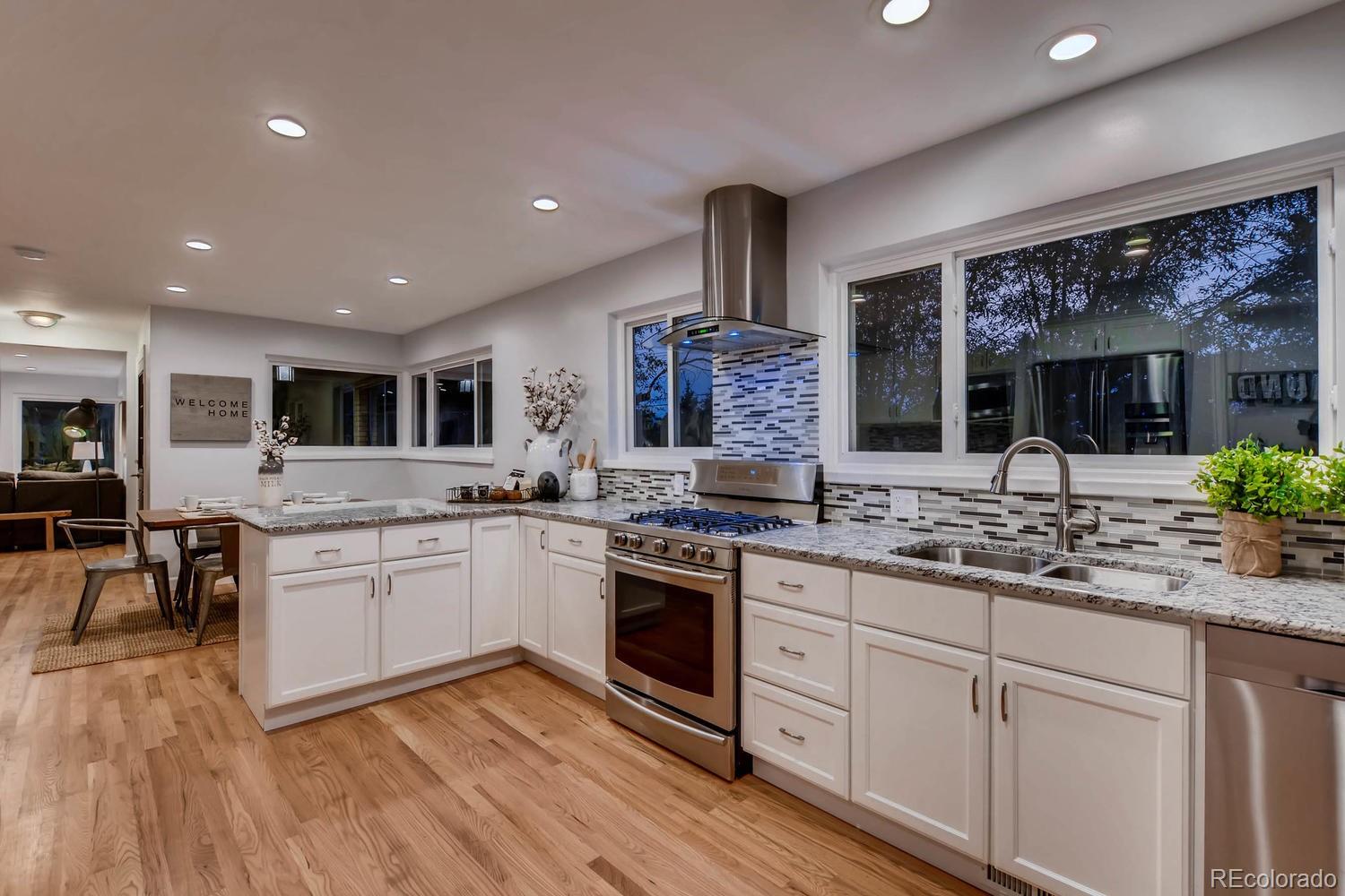 Kitchen featured in Colorado's Best Kitchens magazine! Samsung stainless appliance package, Slab granite countertops, custom cabinets with slow close drawers & doors