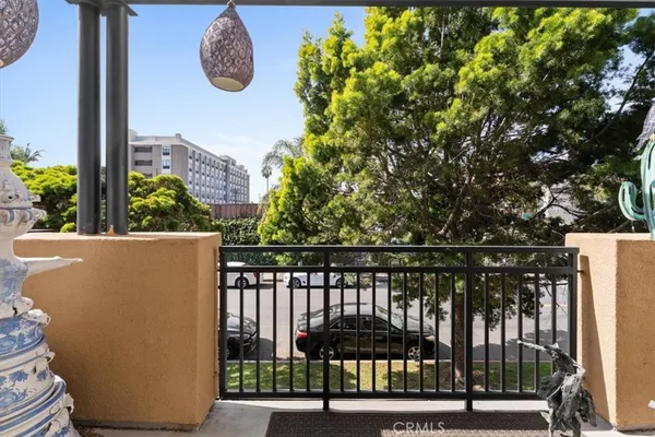 a view of roof deck with wooden floor and fence