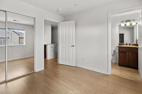 an empty room with closet and wooden floor