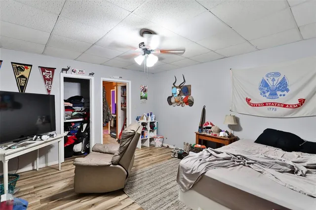 a bedroom with furniture and a flat screen tv