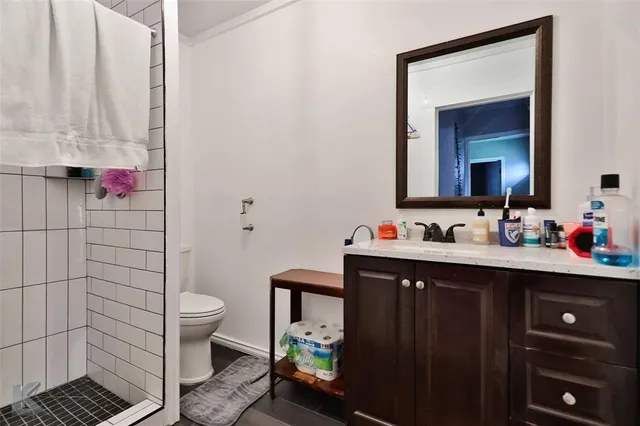 a bathroom with a sink a toilet and shower