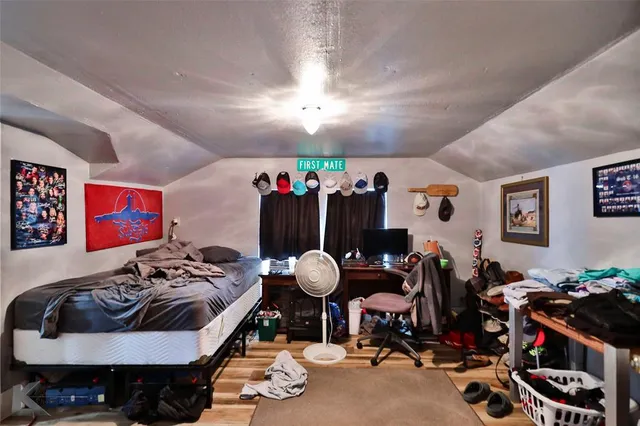 a bedroom with furniture and a mirror