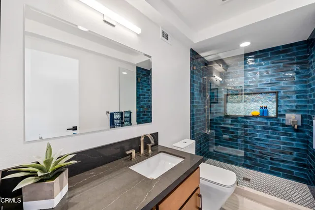 a bedroom with a large bed and a view of kitchen