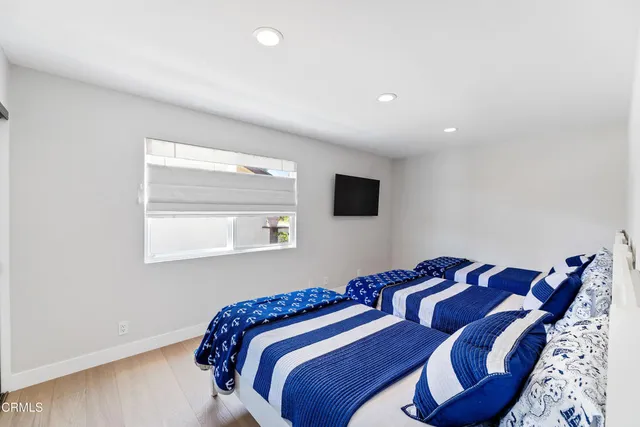 a bedroom with a bed and a painting on the wall