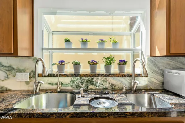 a dining room with furniture a rug and a floor to ceiling window