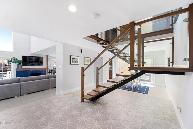 a view of a patio with table and chairs under an umbrella