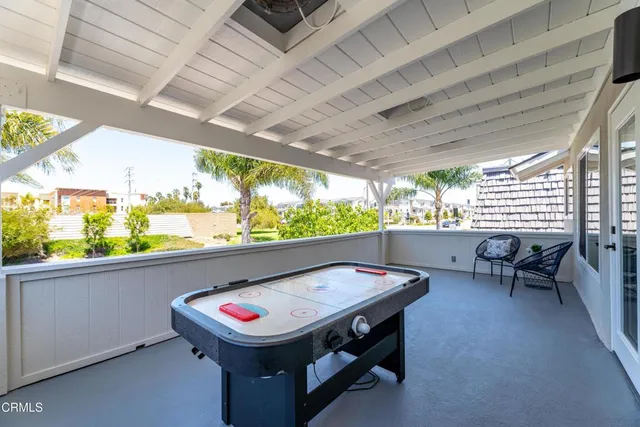 a bedroom with a bed couch and a large window