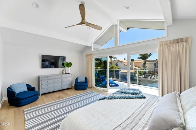 a bed sitting in a bedroom and painting on the wall