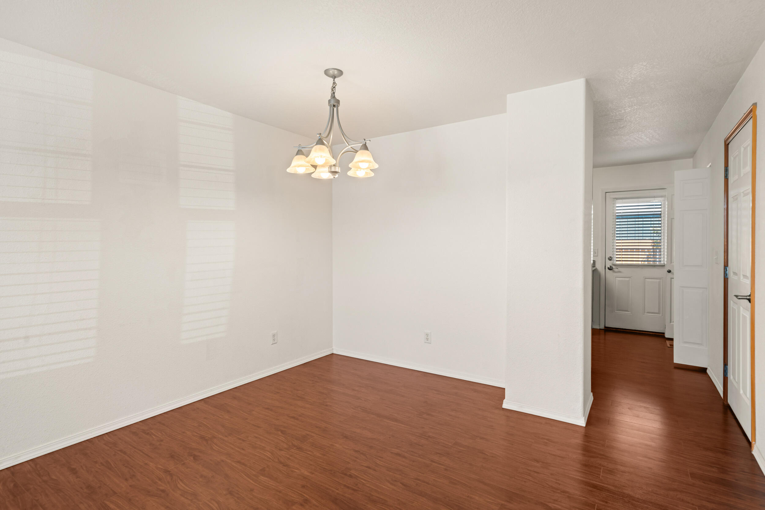 450 Midway Road, Unit 33 Medford, OR 97501 - Photo 8 of 21 a view of a room with wooden floor and chandelier