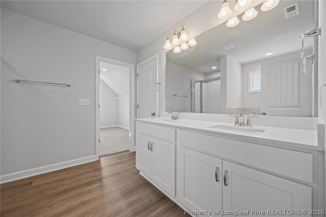 155 Michter Street Vass, NC 28394 - Photo 25 of 46 a bathroom with a double vanity sink and a mirror