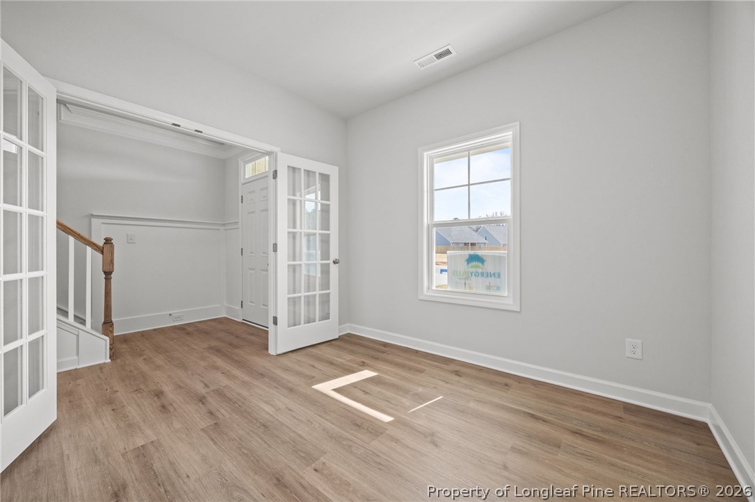 155 Michter Street Vass, NC 28394 - Photo 28 of 46 an empty room with wooden floor and windows